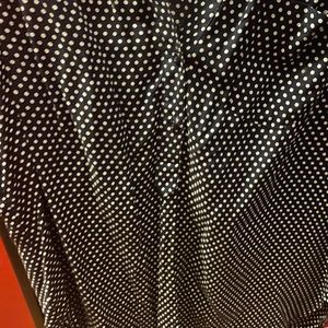 Sleeveless navy blue/white polka dot blouse.